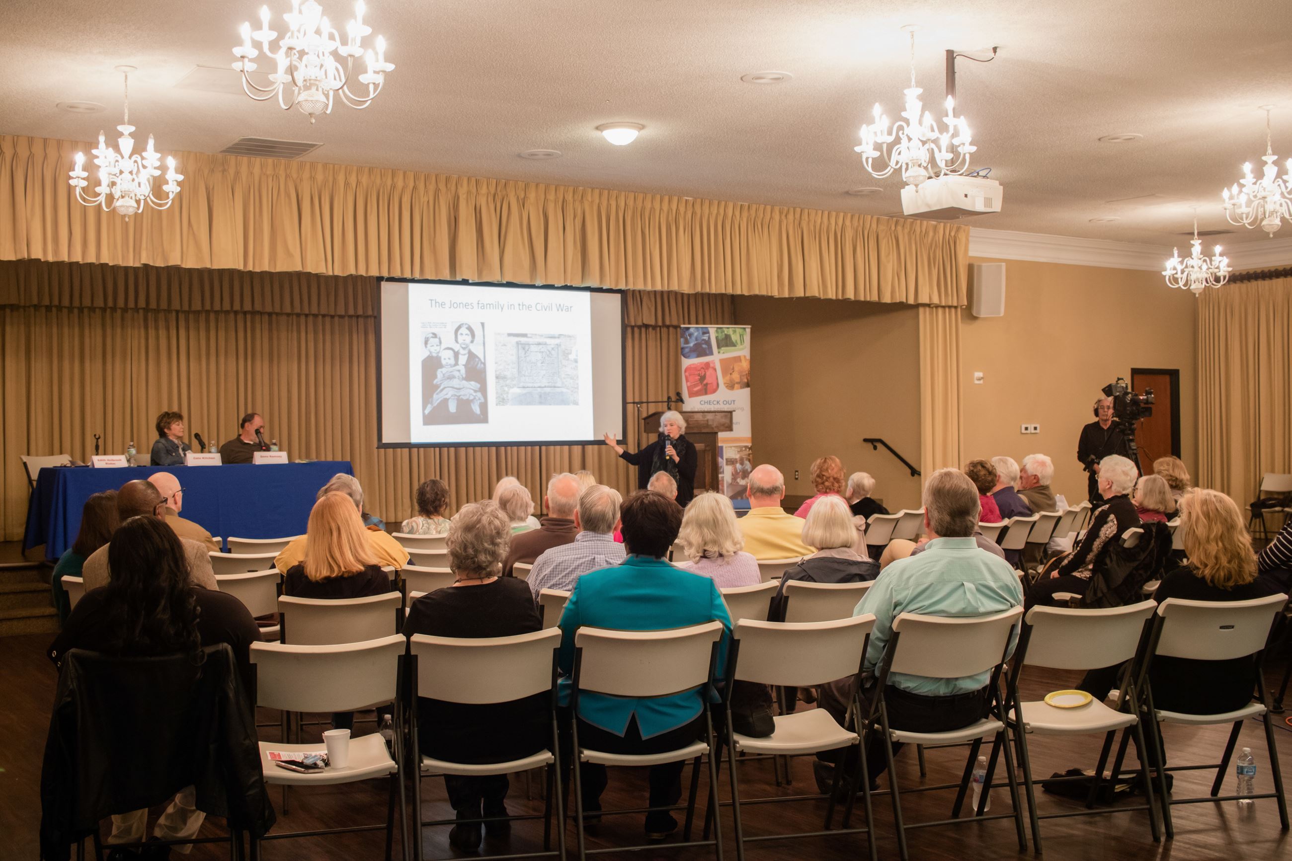 seminar audience watching speaker and projector in ballroom