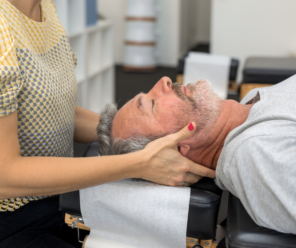 Chiropractor adjusting patient's neck