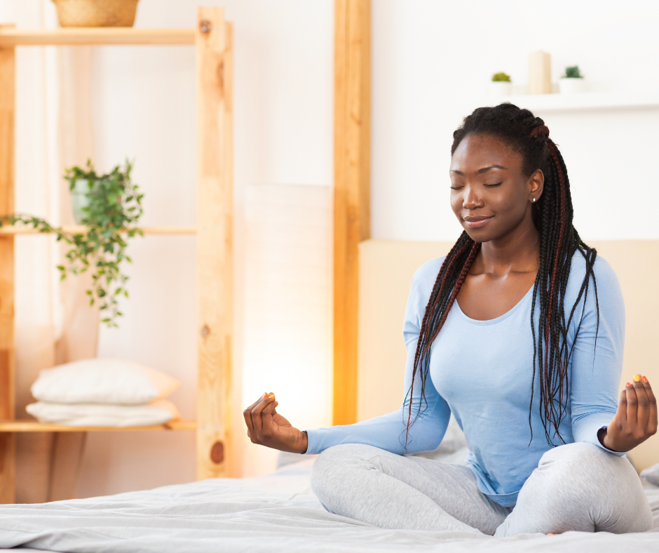 African American women doing yoga in her home