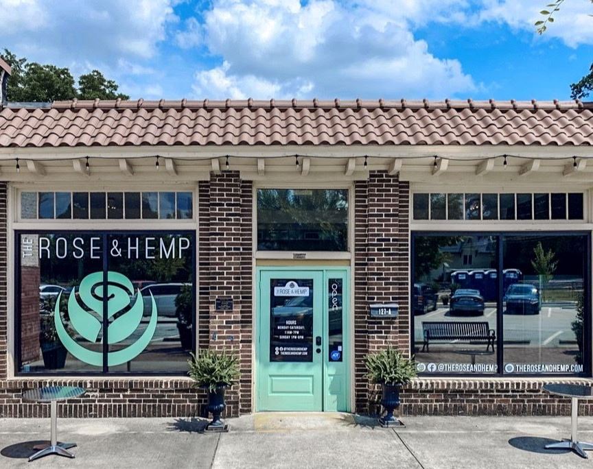 Exterior brick building with mint colored door