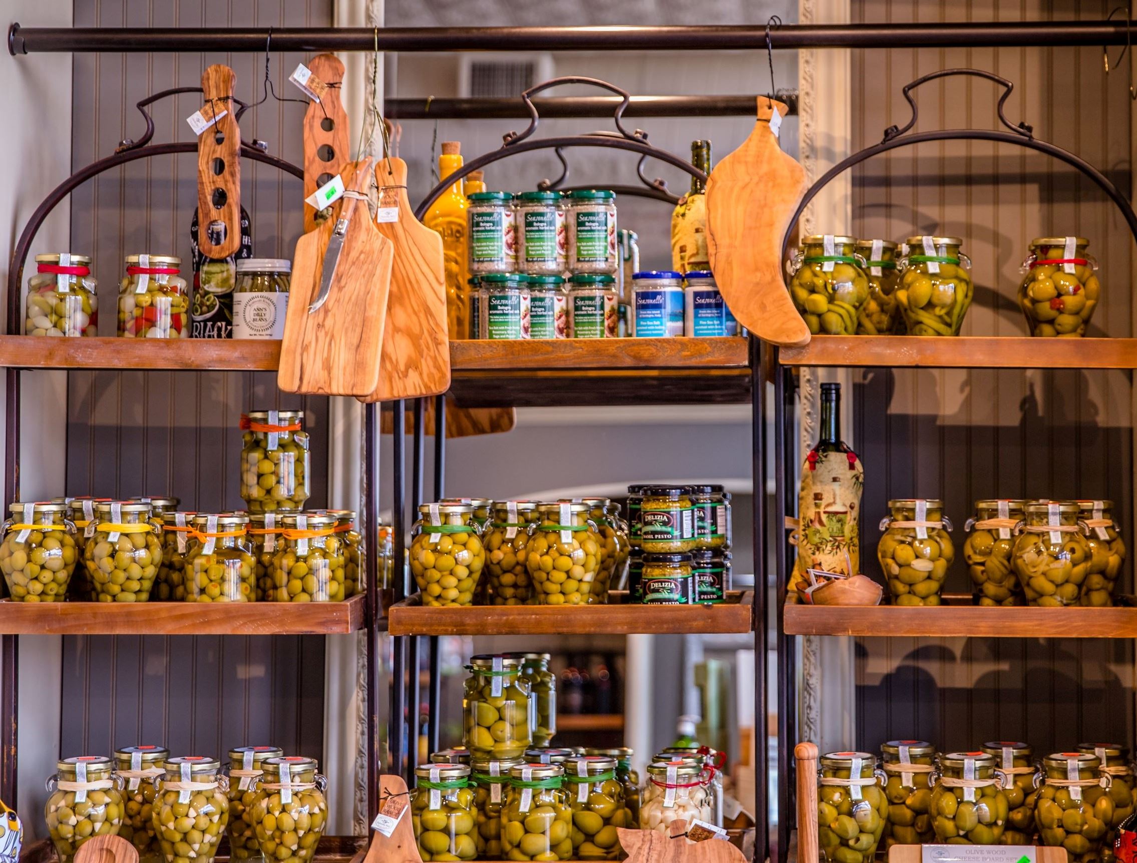 Shelves full with jar of green olives